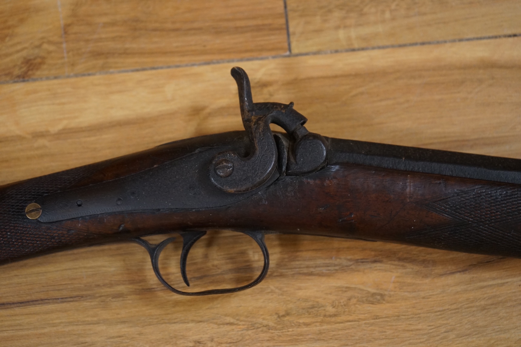 An English 16 bore back action, single barrel, percussion sporting gun, with half octagonal barrel half-stocked, barrel 82cm, iron mounted, chequered grip and fore end